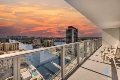 a view from the balcony of a building with a sunset at Wrap Around Balcony Insane Views Amazing Pools in Hollywood