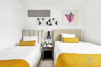 two beds sitting next to each other in a bedroom at Wrap Around Balcony Insane Views Amazing Pools in Hollywood