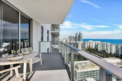 a balcony with a table and a view of the ocean at Wrap Around Balcony Insane Views Amazing Pools in Hollywood