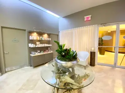 a room with a glass table with a plant on it at 21st Floor Luxury Suite at Trump Int Resort in Miami Beach