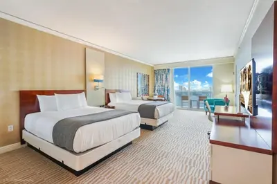 a hotel room with two beds and a balcony at 21st Floor Luxury Suite at Trump Int Resort in Miami Beach