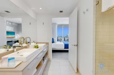 a bathroom with a sink and a bed in a room at Luxury 2Br Front Ocean Bay View Amazing Pools in Hollywood