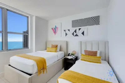two beds in a room with a window at Luxury 2Br Front Ocean Bay View Amazing Pools in Hollywood
