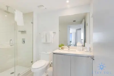 a bathroom with a toilet and a sink and a shower at Luxury 2Br Front Ocean Bay View Amazing Pools in Hollywood