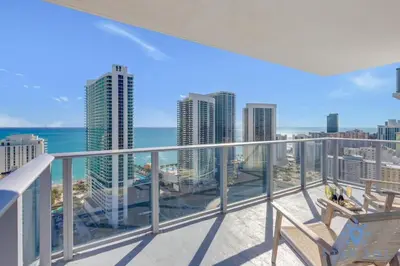 a balcony with a view of the ocean and buildings at Luxury 2Br Front Ocean Bay View Amazing Pools in Hollywood
