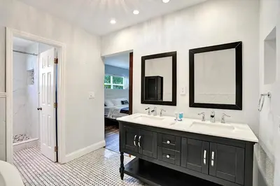 a bathroom with a sink and two mirrors at Wonderful 4BR and 3BA Villa Heated Pool near Beach in Hollywood