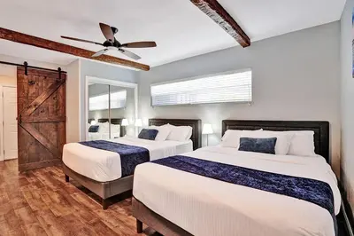 a bedroom with two beds and a ceiling fan at Wonderful 4BR and 3BA Villa Heated Pool near Beach in Hollywood