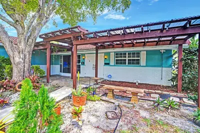 a house with a bench in front of it at Wonderful 4BR and 3BA Villa Heated Pool near Beach in Hollywood