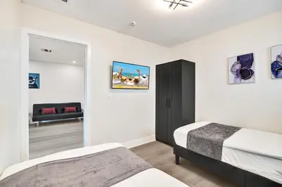 a bedroom with two beds and a living room at Luxury Villa with Heated Pool close to Beach in Hollywood