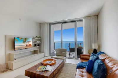 a living room with a view of the ocean at Insane Ocean View Balcony Beachfront Condo Pool in Hollywood