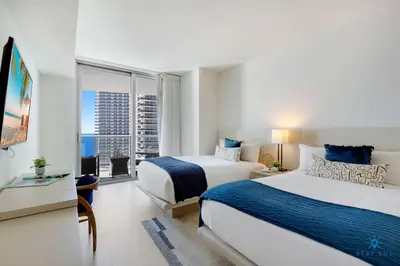 a hotel room with two beds and a window at Insane Ocean View Balcony Beachfront Condo Pool in Hollywood