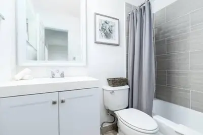 a white bathroom with a toilet and a sink at Heart Of Wilton 1 Recently Remodeled in Fort Lauderdale
