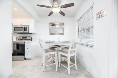 a kitchen with a table and chairs and a ceiling fan at Heart Of Wilton 1 Recently Remodeled in Fort Lauderdale
