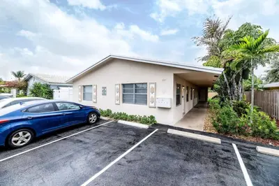 a car parked in a parking lot in front of a house at Heart Of Wilton 1 Recently Remodeled in Fort Lauderdale