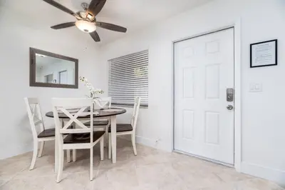 a dining room with a table and chairs and a ceiling fan at Heart of Wilton 3 Recently Remodeled in Fort Lauderdale