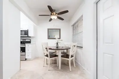 a dining room with a ceiling fan and a table and chairs at Heart of Wilton 3 Recently Remodeled in Fort Lauderdale