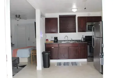 a kitchen with wooden cabinets and a stainless steel refrigerator at Stunning suite by hard rock stadium and casino in Miami
