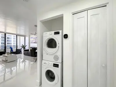 a washer and dryer in a white room at Beach Paradise a cozy ocean view condo on the beach with free parking in Hollywood