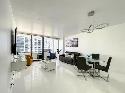 a living room with a couch and a table at Beach Paradise a cozy ocean view condo on the beach with free parking in Hollywood