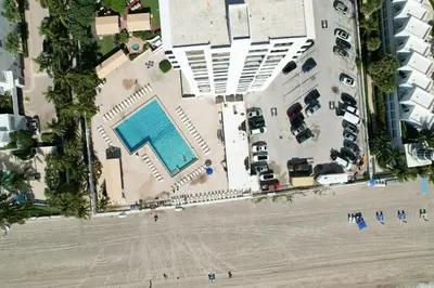 an aerial view of a beach with a swimming pool at Beach Paradise a cozy ocean view condo on the beach with free parking in Hollywood