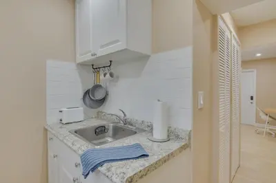 a kitchen with a sink and a counter top at Refreshing Miami Apartment 4 Mi to the Beach! in Miami