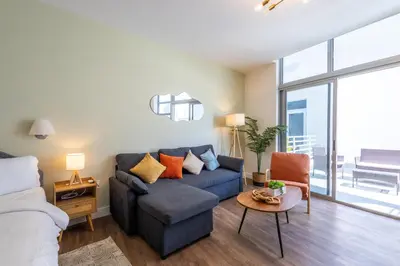 a living room with a couch and a table at Rooftop-Pool King Bed Suite on Ocean Dr C305 in Miami Beach
