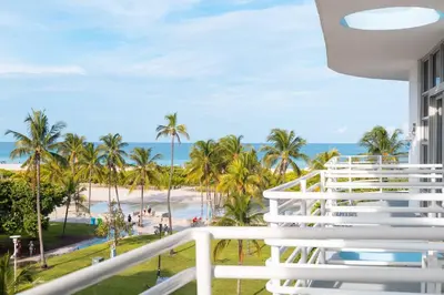 a balcony with a view of the beach and palm trees at 1 Bedroom with King Bed and Roof-Top Pool and Bar C503 in Miami Beach