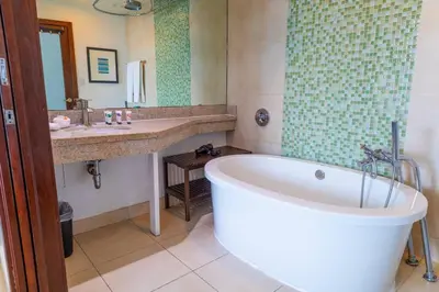 a bathroom with a large tub and a sink and a tub at 1 Bedroom with King Bed and Roof-Top Pool and Bar C503 in Miami Beach