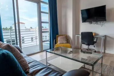 a living room with a couch and a glass coffee table at 1 Bedroom with King Bed and Roof-Top Pool and Bar C503 in Miami Beach