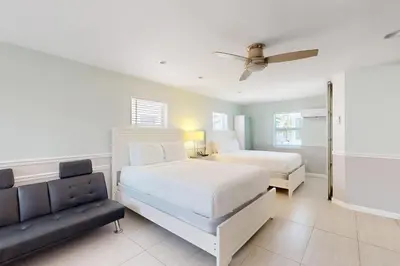 a bedroom with two beds and a couch at Hollywood Bungalow in Hollywood