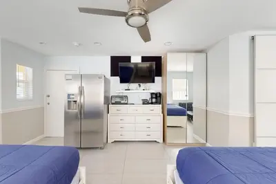 a kitchen with two beds and a refrigerator in a room at Hollywood Bungalow in Hollywood