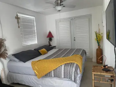 a bedroom with a bed with a yellow blanket on it at Master King Suite by Hard rock stadium and casino in Miami