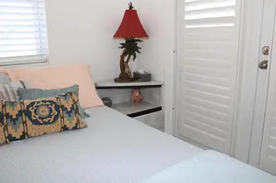a bedroom with a bed with a red lamp at Master King Suite by Hard rock stadium and casino in Miami