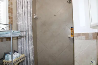 a shower in a bathroom with a shower curtain at Master King Suite by Hard rock stadium and casino in Miami
