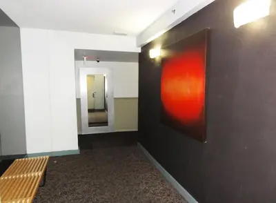 a hallway with a painting on the wall and a bench at South Beach Paradise: best of Miami in Miami Beach