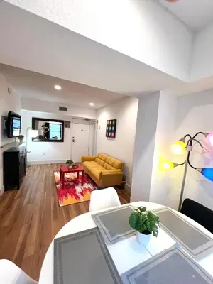 a living room with a yellow couch and a table at South Beach Paradise: best of Miami in Miami Beach