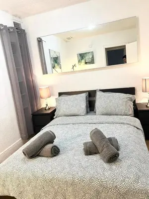 a bedroom with a large bed with two pillows at South Beach Paradise: best of Miami in Miami Beach