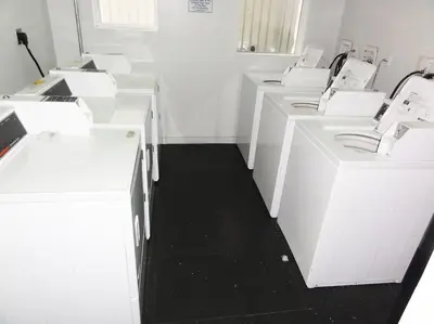 a white room with white cabinets and a black floor at South Beach Paradise: best of Miami in Miami Beach