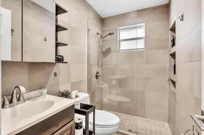 a bathroom with a toilet and a sink and a shower at Estelo's Place - Modern townhouse with King bed, only 5 min from the Airport! in Miami