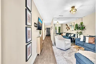 a living room with a blue couch and a table at Estelo's Place - Modern townhouse with King bed, only 5 min from the Airport! in Miami