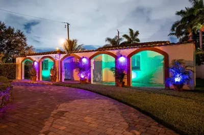a house decorated with purple and green lights at ~Villa Victoria Luxury! (Pool)~1 mile from beach in Fort Lauderdale