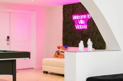 a room with a pink room with a pool table at ~Villa Victoria Luxury! (Pool)~1 mile from beach in Fort Lauderdale