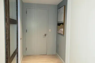 a hallway with a white door and a mirror at Gorgeous Upscale Condo in the Middle of Brickell in Miami