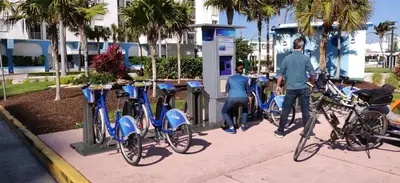 a group of people fueling their bikes at a fueling station at Beach Front Studio Miami Beach in Miami Beach