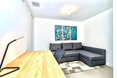 a living room with a couch and a wooden table at Lunabase Tropical Refuge in Miami