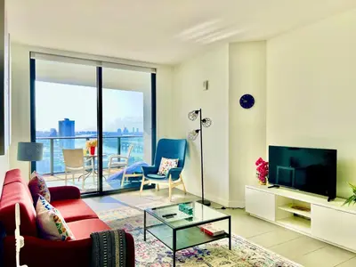 a living room with a red couch and a tv at Lunabase Tropical Refuge in Miami