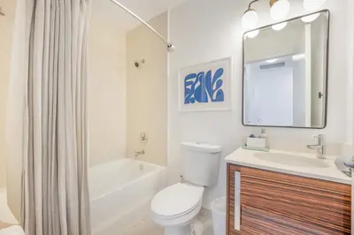 a bathroom with a toilet and a sink and a mirror at Lunabase Waterfront Paradise in Miami