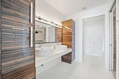 a bathroom with two sinks and a large mirror at Lunabase Waterfront Paradise in Miami