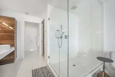a bathroom with a glass shower and a sink at Lunabase Waterfront Paradise in Miami