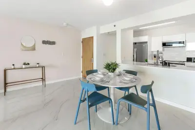 a dining room with a table and chairs and a kitchen at Brickell Bay View Oasis with Pool Hot Tub and Gym in Miami